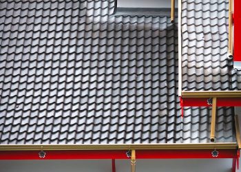 An architectural shot of a house exterior featuring a contemporary, tiled roof design.